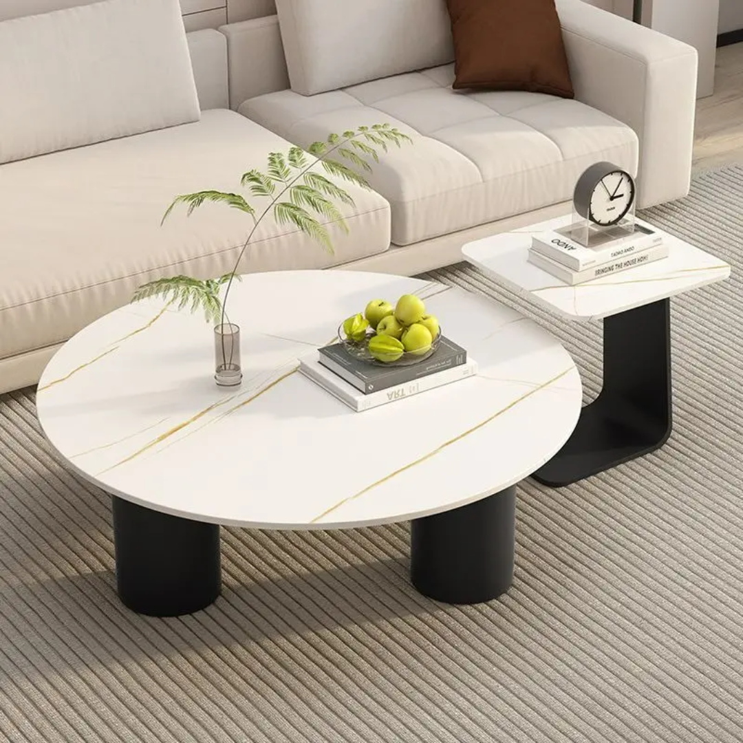Round coffee table with decorative items in a living room setting
