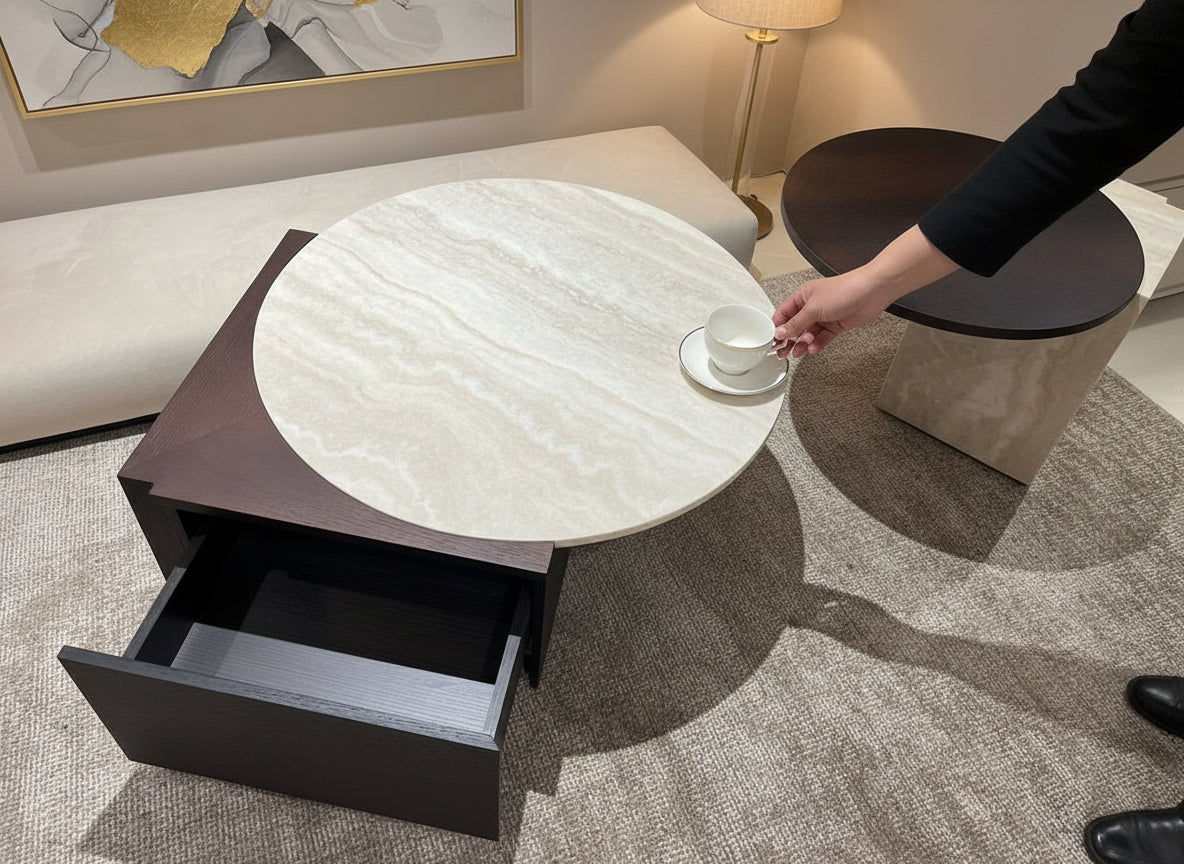 Round marble coffee table with a drawer in a modern living room setting.