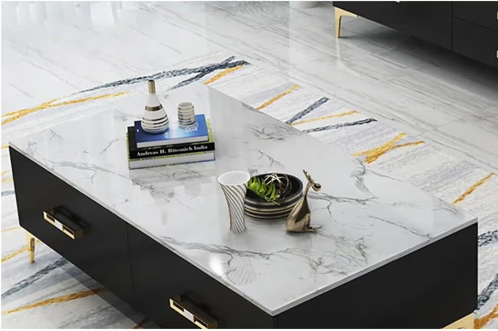 Modern coffee table with marble-like top and black base in a living room setting.