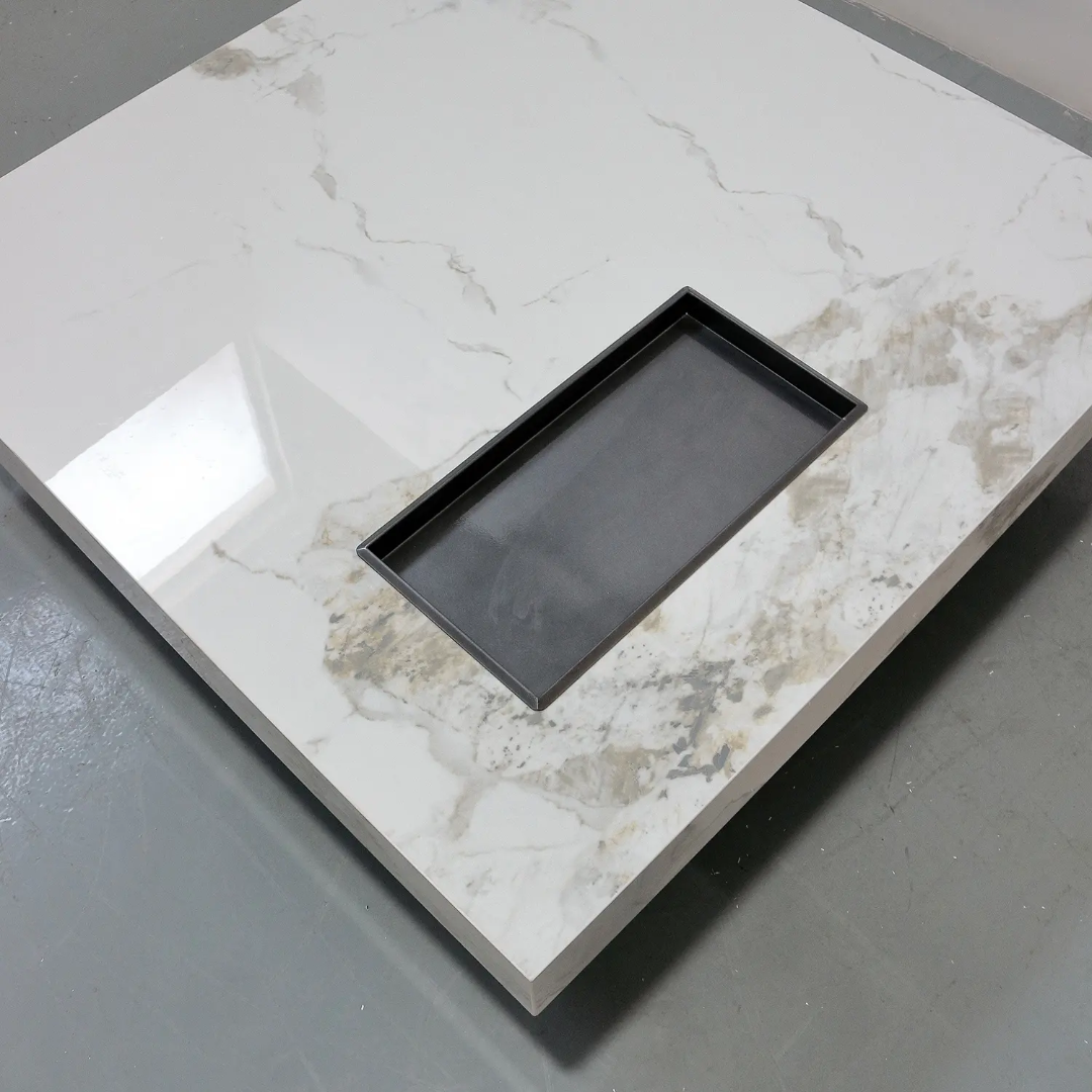 Black rectangular tray on a marble-patterned surface