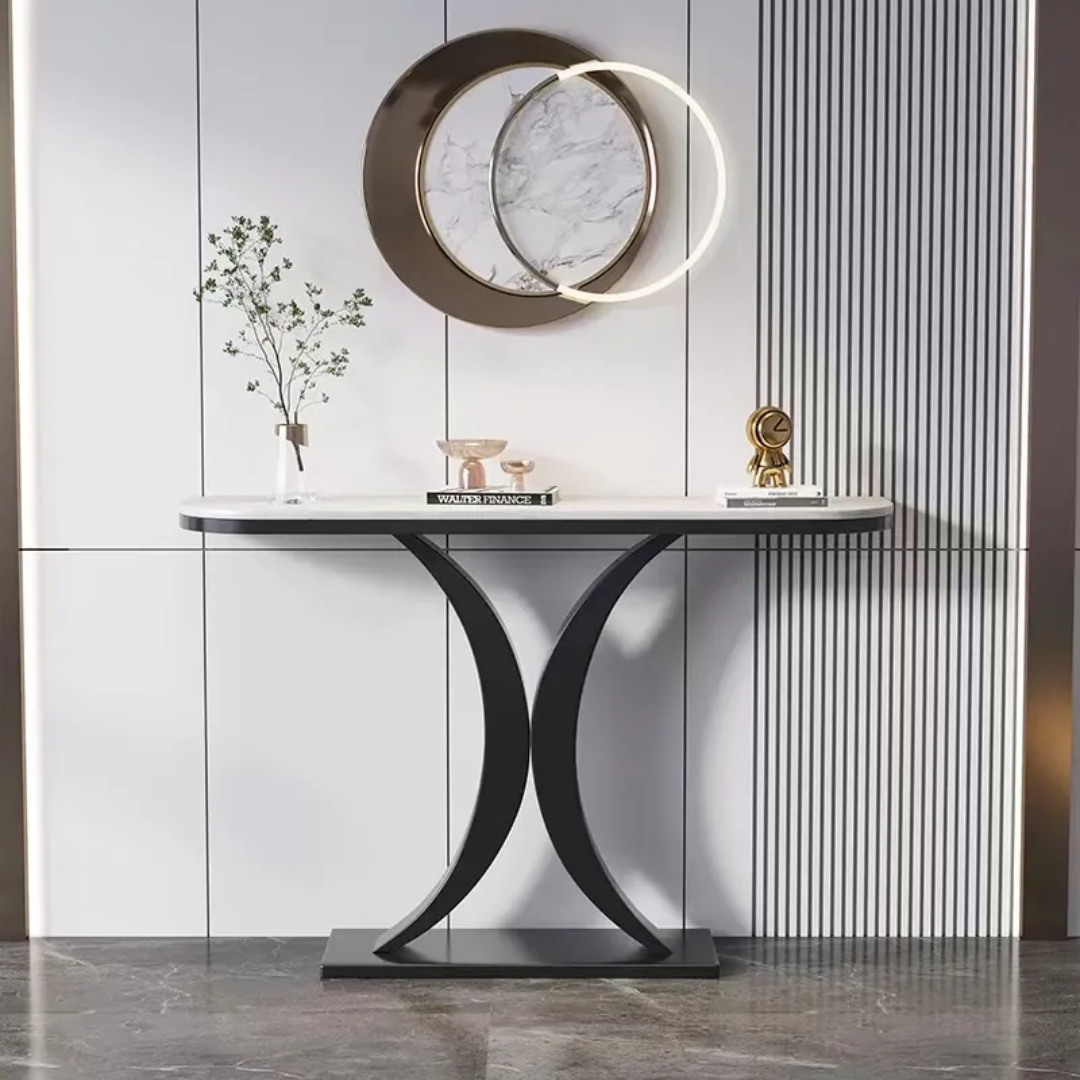 Modern console table with decorative items against a striped wall.