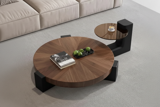 Round wooden coffee table with black legs in a living room setting.
