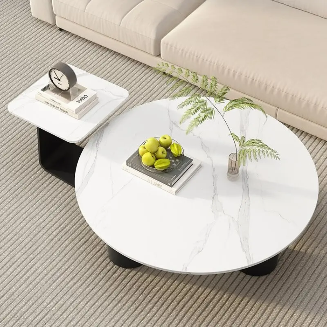 Round white coffee table with decorative items in a living room setting