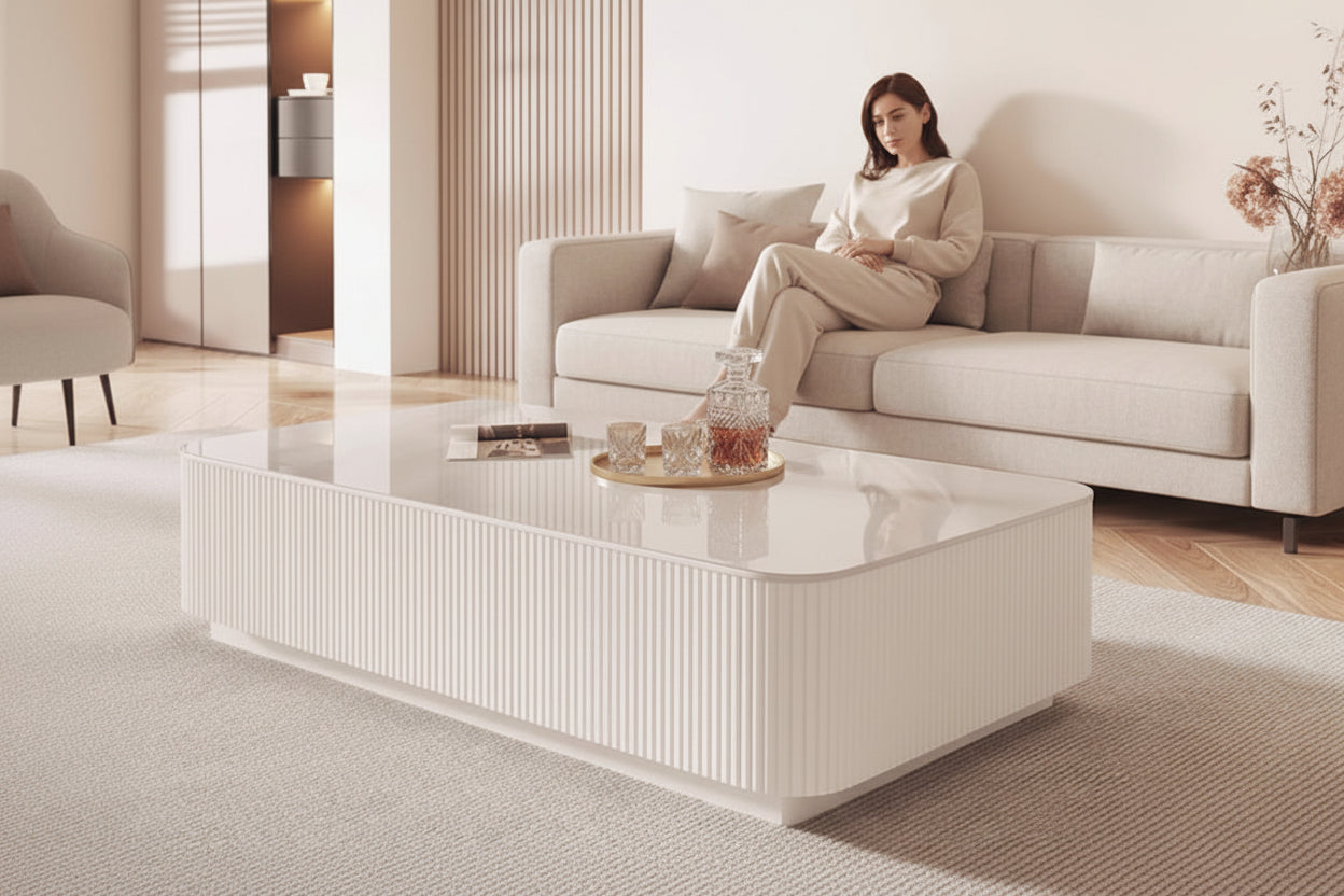 Modern living room with a white coffee table and decorative items.