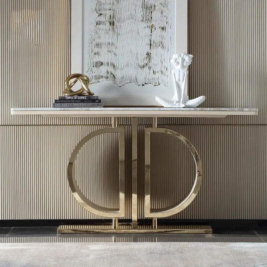Decorative console table with gold circular design against a striped wall.