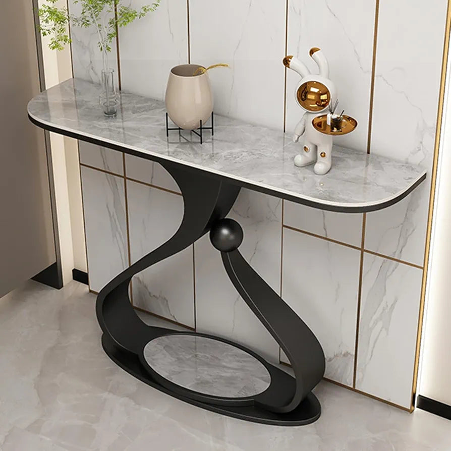 Modern console table with marble top and black base against a tiled wall.