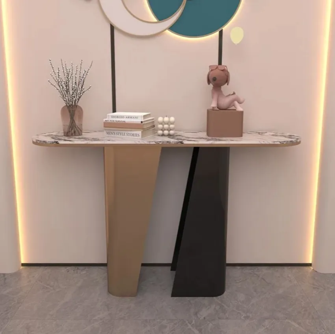 Modern console table with decorative items against a wall with circular light fixtures.