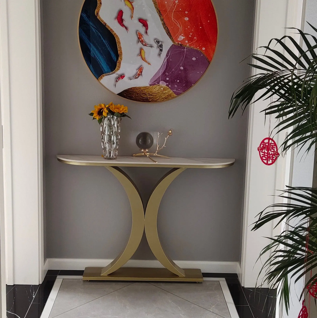 Modern console table with decorative items against a gray wall