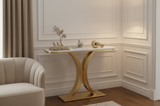 Modern console table with gold base and white marble top on a white background