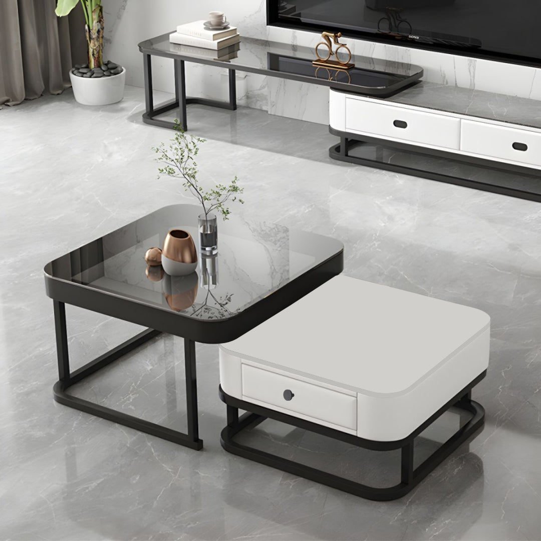 Modern living room with a glass coffee table and white ottoman.
