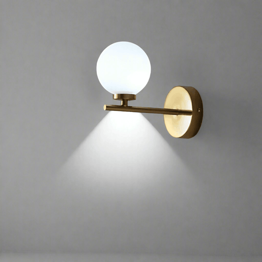 Modern N I CREATIONS wall lamp featuring a golden finish and a round glass shade for stylish lighting