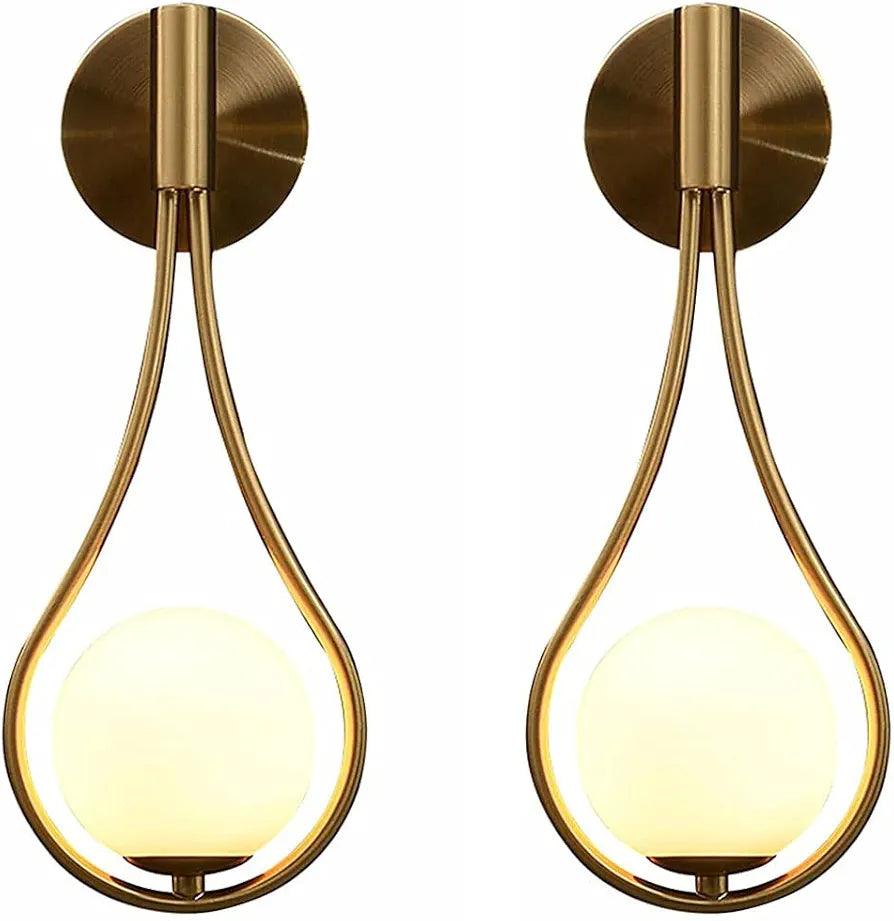 Elegant N I CREATIONS wall lamp featuring a modern design with a golden finish and a round glass shade
