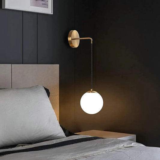 N I CREATIONS modern wall lamp with a sleek design, illuminating a stylish bedroom